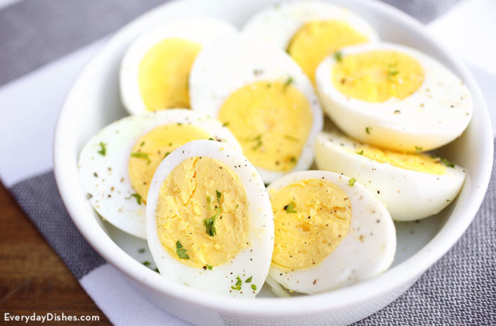 A bowl of perfect hardboiled eggs, sliced in half.