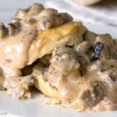 A plate with delicious sausage gravy and biscuits, the perfect breakfast.