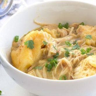 A bowl of a delicious slow cooker chicken and dumplings with green chilis.