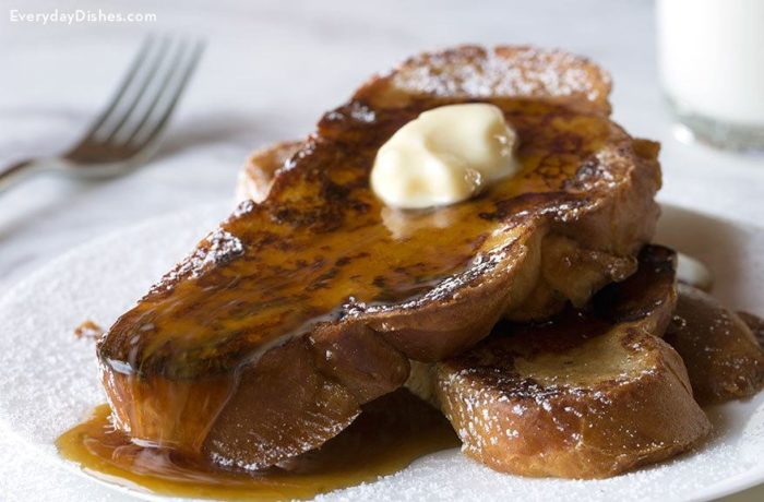 Two slices of easy French toast, topped with butter and syrup and ready to enjoy for breakfast.