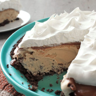 A homemade frozen mocha pie with a slice taken out of it.