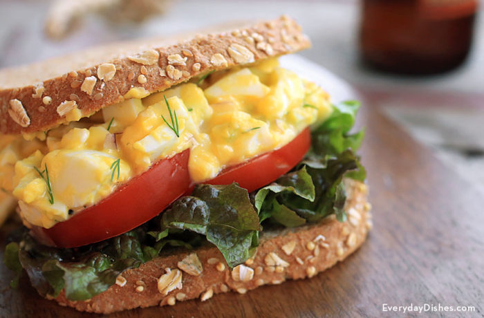 A sandwich made of no-mayo egg salad and vegetables.