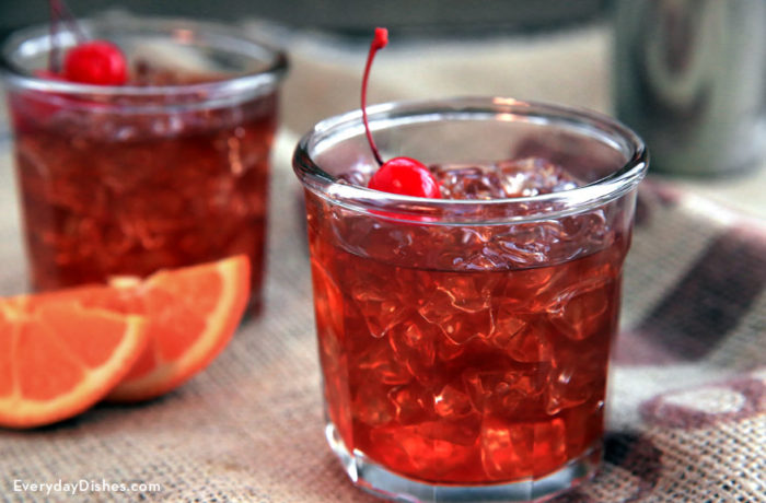 Two glasses of a refreshing red patriotic rum cocktail with a cherry garnish