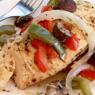 A plate with a serving of baked Italian chicken, a delicious dinner.