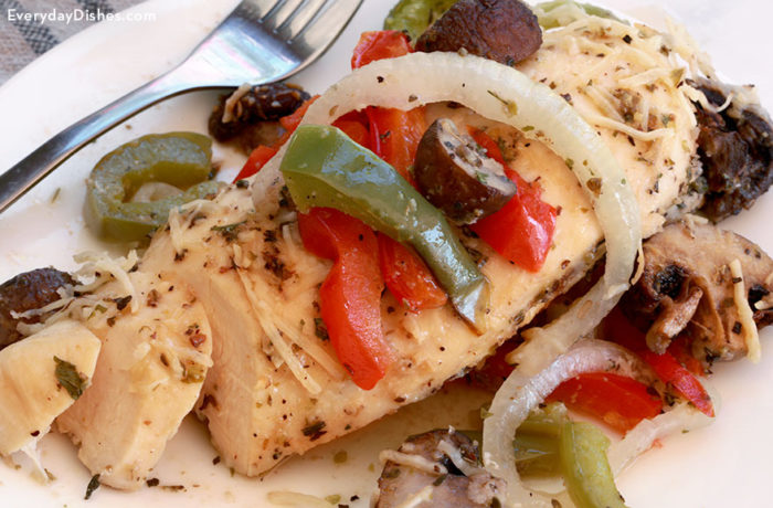 A plate with a serving of baked Italian chicken, a delicious dinner.