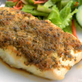 Chinese baked halibut that's on a plate and ready to eat for dinner.