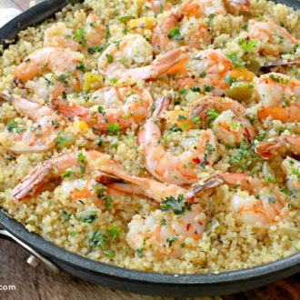 A skillet full of a garlic butter shrimp and quinoa, an amazing dinner.