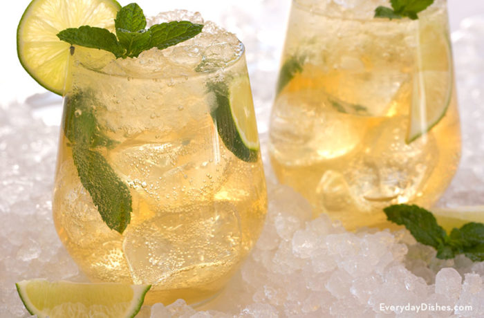 Two glasses of a honey mint whiskey mojito
