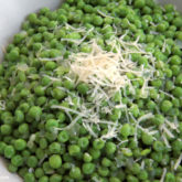 A bowl of some delicious parmesan Italian peas — a great side dish!