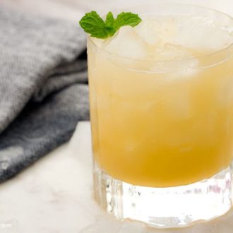 A refreshing pineapple mojito cocktail, garnished with mint.
