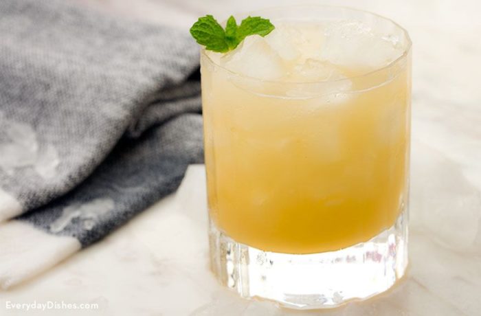 A refreshing pineapple mojito cocktail, garnished with mint.