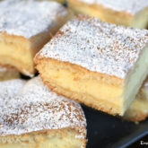 A batch of lemon cream cheese bars, cut into squares and ready to serve for dessert.