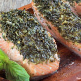 Delicious and nutrient-rich roasted salmon filet with fresh basil and Parmesan cheese, ready to serve for dinner.