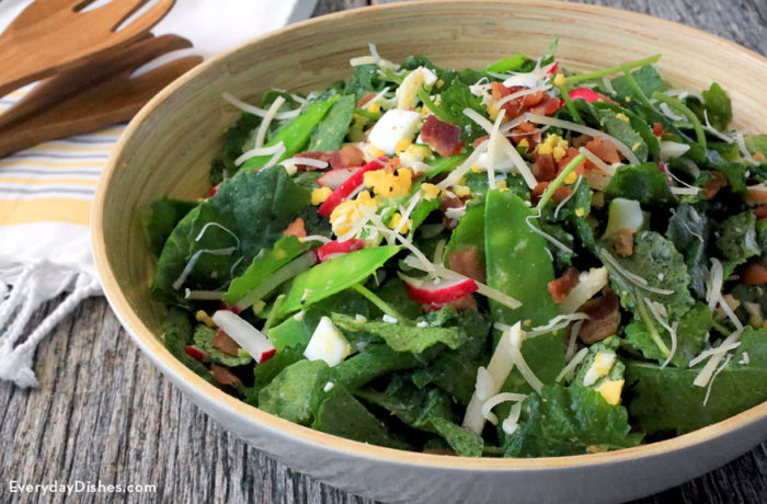 A delicious baby green salad with egg and bacon, ready to serve and enjoy.