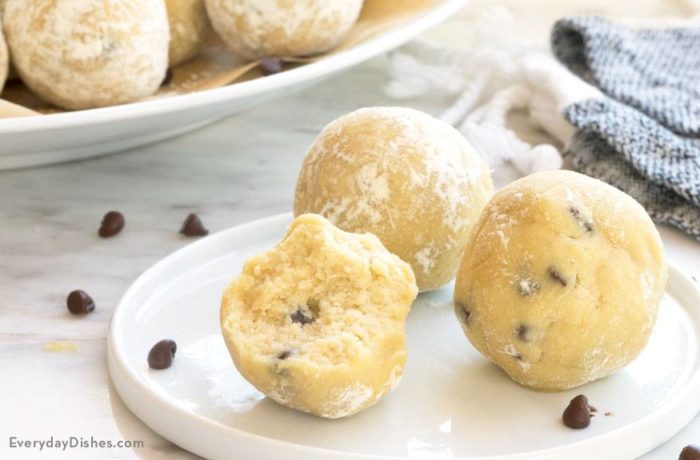 A trio of frozen cookie dough bites on a plate.