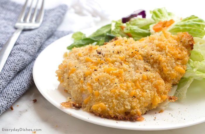 A plate of delicious ranch cheddar chicken, served with a side salad, and ready to eat for dinner.