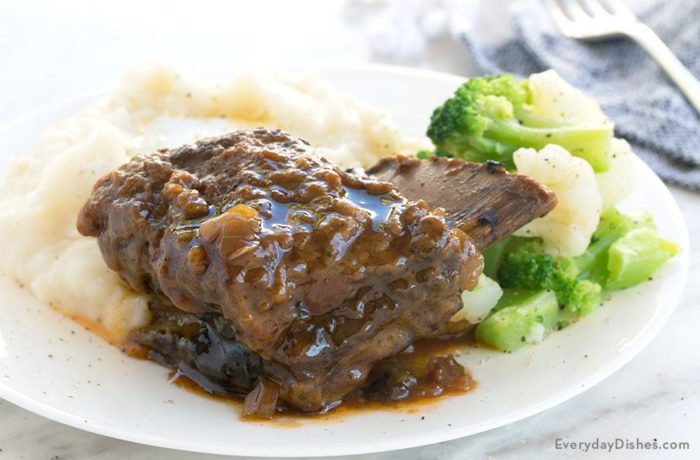 A plate of braised short ribs, served with broccoli and mashed potatoes for a hearty dinner.