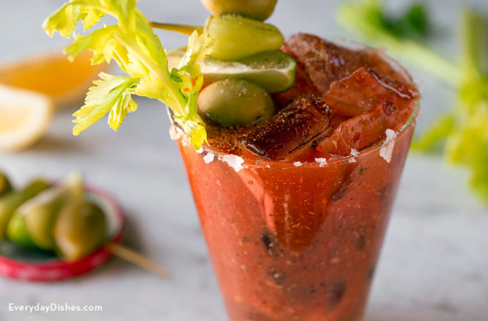 A glass full of a classic bloody Mary drink.