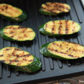 Freshly made grilled zucchini on an electric skillet.
