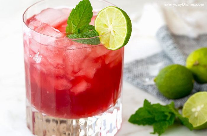 A refreshing glass of cranberry mojito with key lime