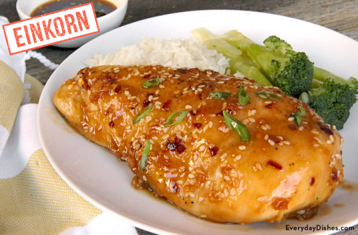 A baked einkorn sesame garlic chicken on a plate with broccoli and rice — a delicious and healthy dinner.