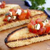 Slices of bread with a tomato basil bruschetta topping