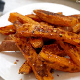 A plate with some delicious homemade baked sweet potato fries.