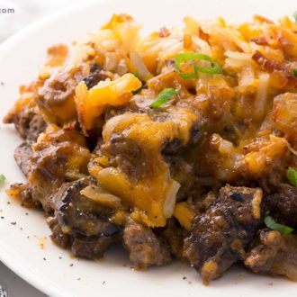 A plate of hamburger hash brown casserole, ready to enjoy for dinner.