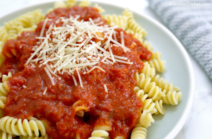 A plate of pasta with homemade marinara sauce and parmesan cheese. A delicious dinner.