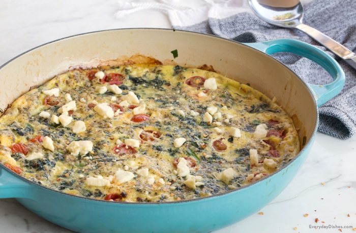A delicious spinach and feta frittata in the pan, ready to serve.