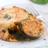 A plate with a delicious serving of baked eggplant parmesan.