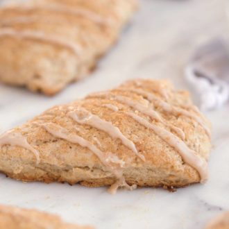 Freshly baked, glazed cinnamon scones.