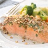 A slice of pecan-crusted honey mustard salmon on the table for dinner