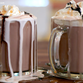 Two mugs of a salted caramel hot chocolate cocktail
