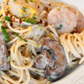 A plate of creamy shrimp and mushroom pasta.