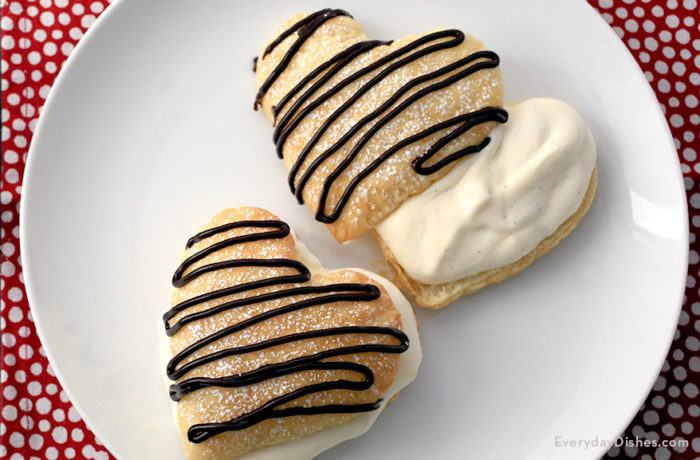 Two heart-shaped Napoleons dessert cookies on a plate, ready to enjoy for Valentine's Day.
