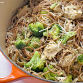 A skillet full of leftover chicken and broccoli pasta