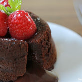 A delicious molten lava cake that's garnished with raspberries, perfect for Valentine's Day