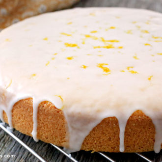 A homemade rustic olive oil cake that's on a cooling rack.