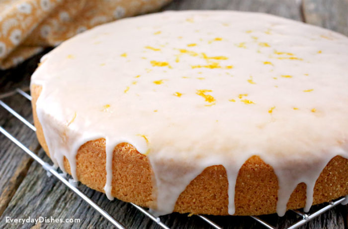 A homemade rustic olive oil cake that's on a cooling rack.