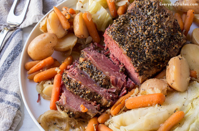 A freshly made corned beef with veggies that was made in a slow cooker.