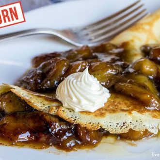 A plate of delicious einkorn bananas Foster crepes, ready to enjoy.