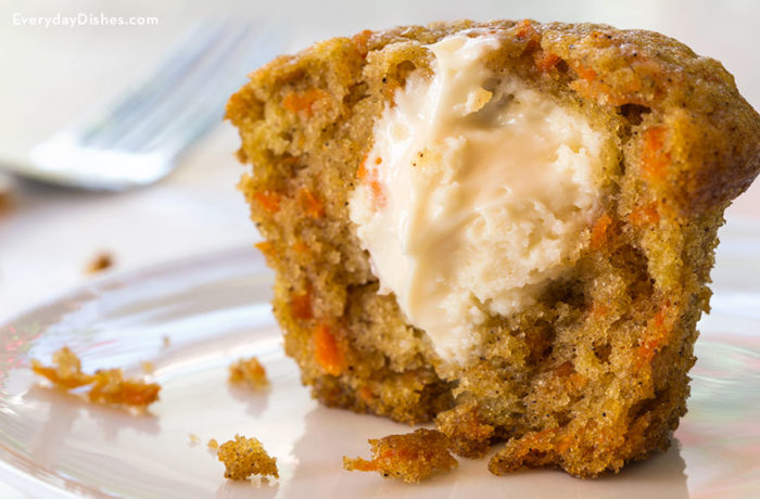 An inside-out carrot cake muffin that's sliced in half.