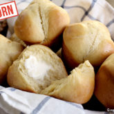A basket full of freshly made einkorn clover yeast rolls.