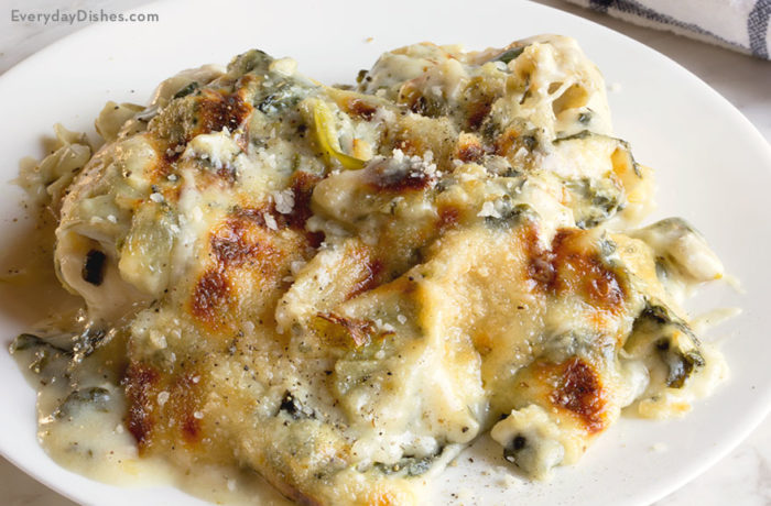 A serving of artichoke chicken florentine casserole that's ready to enjoy for dinner.