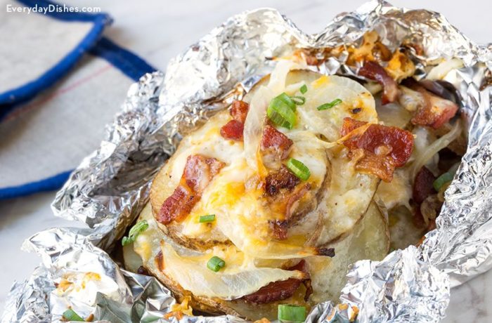 A cheesy bacon potato that's cooked in a foil packet.