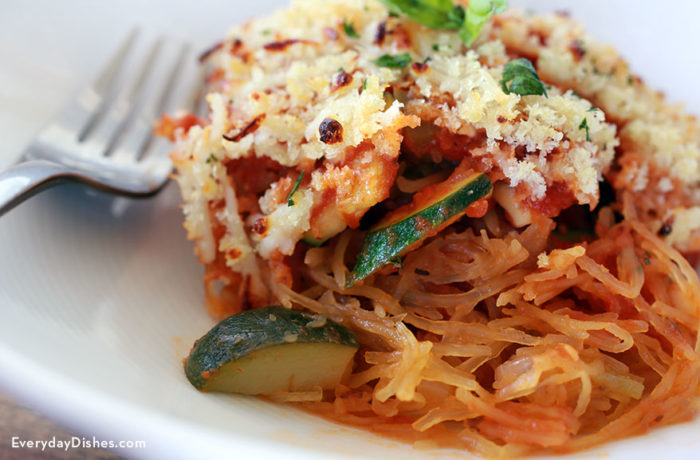 A slice of vegetarian spaghetti squash casserole on a plate and ready to eat for dinner.