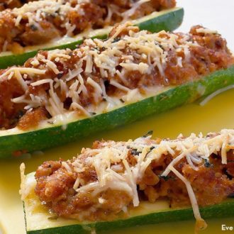 A plate with chicken sausage zucchini boats, a great party appetizer.
