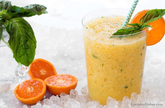 A glass of a delicious citrus basil juice refresher.
