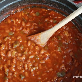 A pot of rich and tangy homemade BBQ baked beans with bacon.